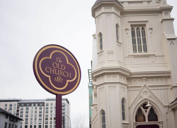 the old church sign in front of a building