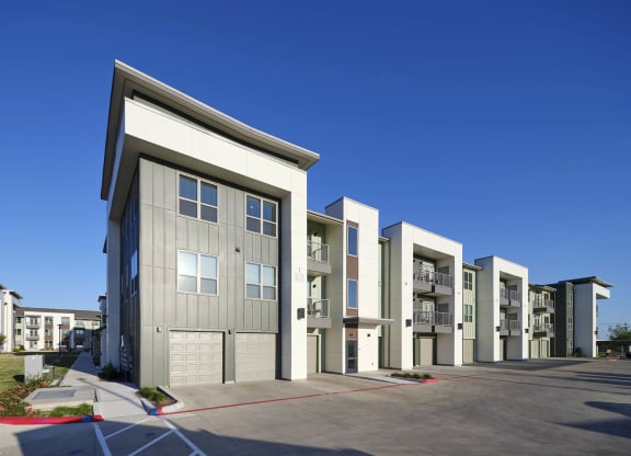 a row of apartment buildings with a blue sky behind them