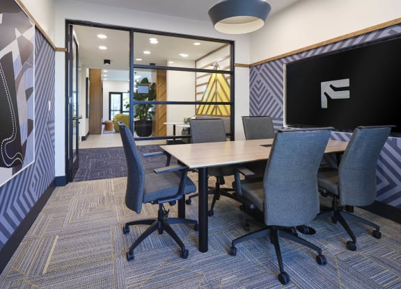 a conference room with a table and chairs