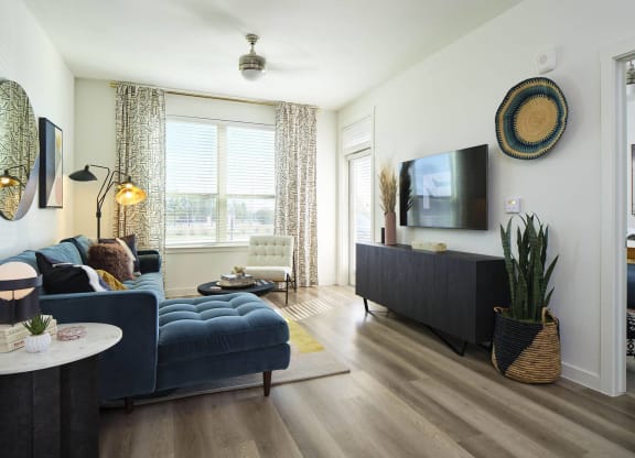 a living room with a blue couch and a tv