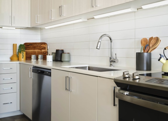 a kitchen with white cabinets and a sink