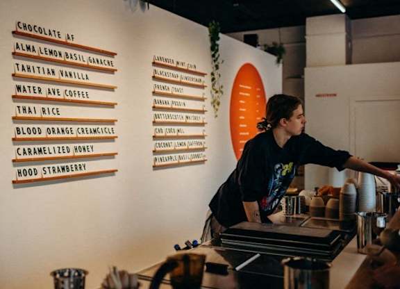 a woman is working at a counter at a restaurant