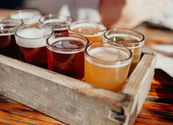 a wooden box filled with different types of beers
