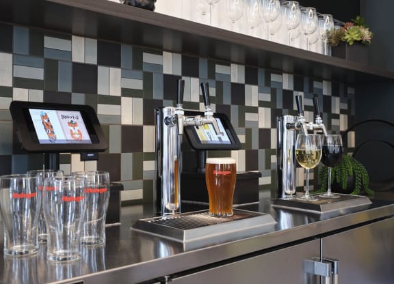 a bar with pitchers of beer and glasses on it