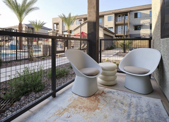 two toilets sitting on a balcony next to a fence