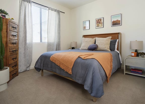 a bedroom with a bed and a dresser