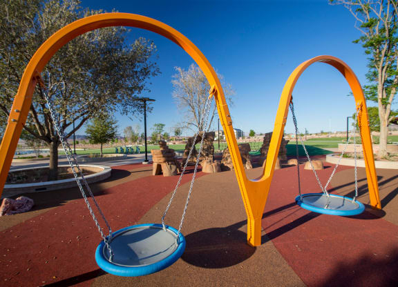 a swing set on a playground at a park