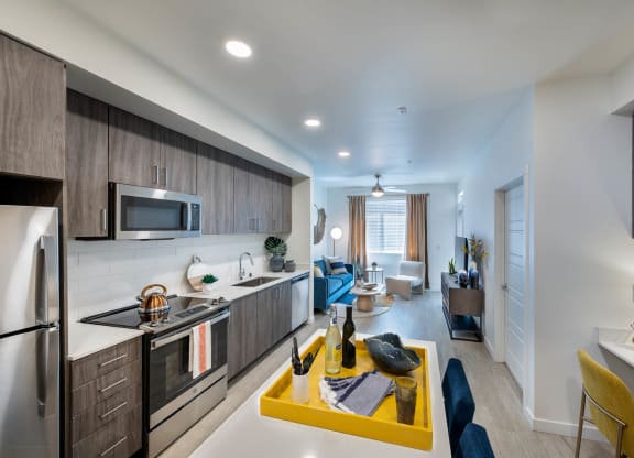 a kitchen and living room with a yellow table