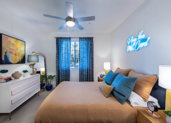 a bedroom with a large bed and a ceiling fan
