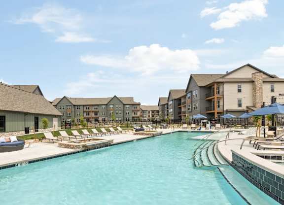 swimming pool lined with lounge chairs