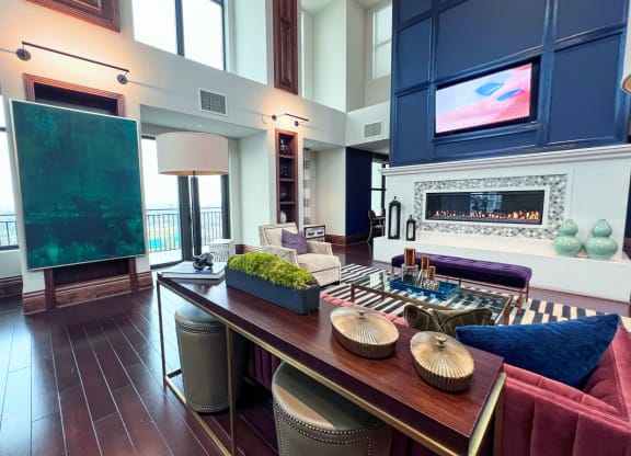 a living room with a long wooden table and a fireplace