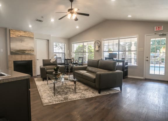 a living room with couches and a coffee table in front of a fireplace