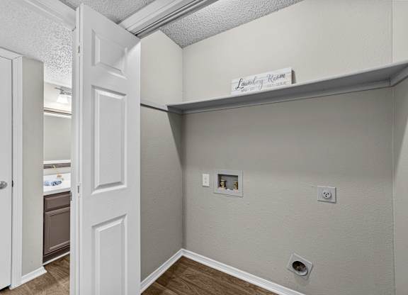 Laundry room with a door and a sign above it.