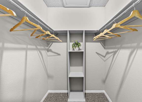 Closet with a shelf and hangers.