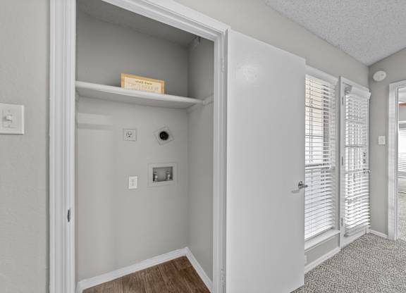 A white door is open to a hallway.