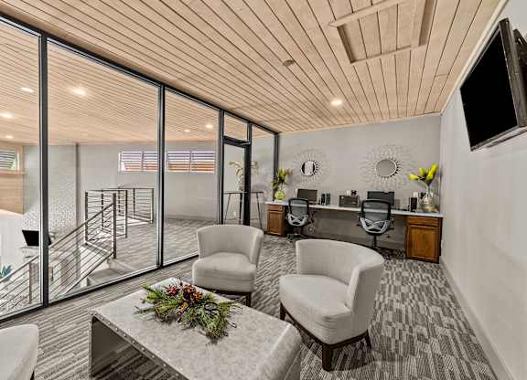 A modern living room with a wooden ceiling and a glass wall leading to a balcony.