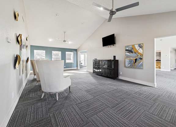A living room with a grey carpet and a white chair.