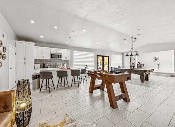 A modern kitchen with a dining table and chairs.