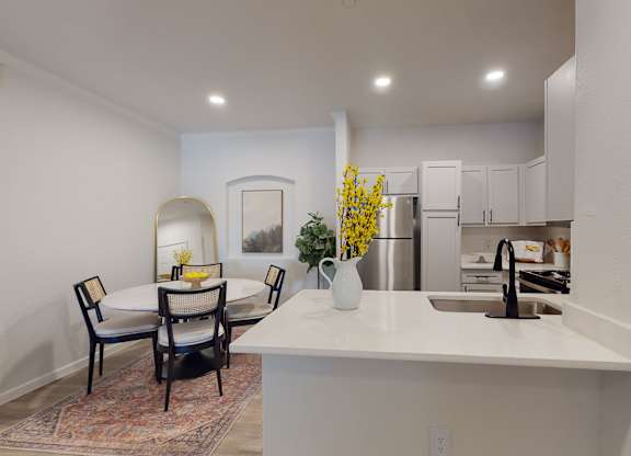 a kitchen and dining area with a table and chairs at Remington Ranch, Texas, 78247