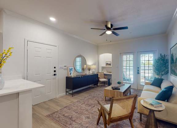 a living room with a ceiling fan and a couch at Remington Ranch, San Antonio, Texas