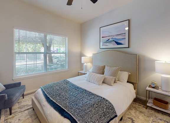 a bedroom with a large bed and a large window  at Remington Ranch, Texas, 78247