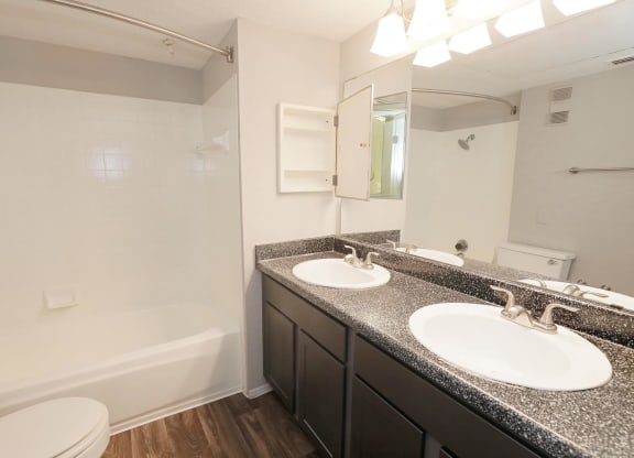 a bathroom with two sinks and a bathtub