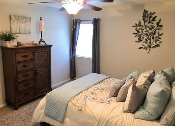 a bedroom with a bed and a dresser