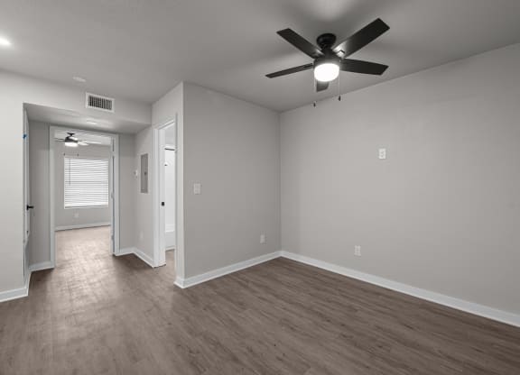 Photo of renovated bedroom with ceiling fan and vinyl flooring at Sunset Heights, San Antonio