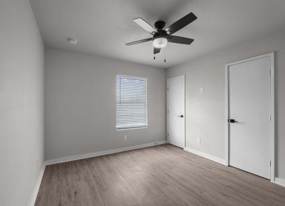 Photo of newly renovated bedroom with vinyl flooring and ceiling fan at Sunset Heights, San Antonio, 78209