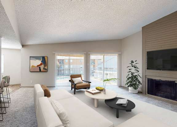 A living room with a white couch, a coffee table, and a fireplace.