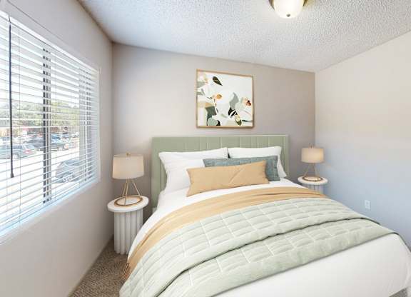 A bedroom with a large bed and a painting on the wall.