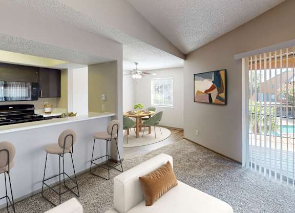 A living room with a bar area and a painting on the wall.