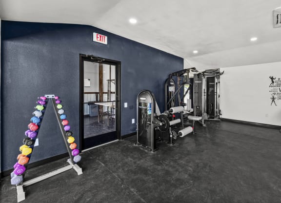 a fitness room with weights and cardio equipment at Peaks at Live Oak in San Antonio, TX