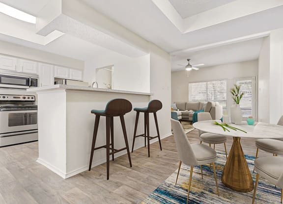 a living room with a kitchen and a dining table