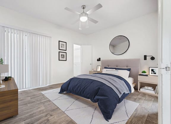 a bedroom with a bed and a ceiling fan