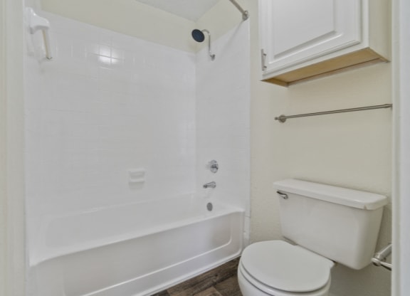 a bathroom with a toilet and a tub and a sink