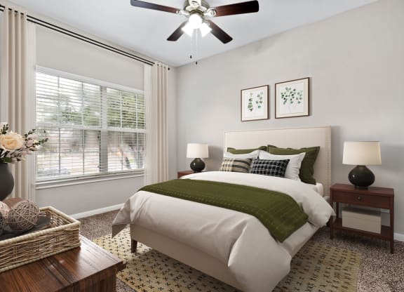 a bedroom with a bed and a ceiling fan