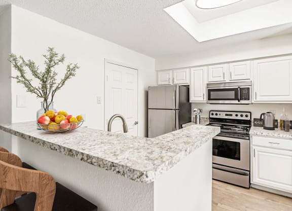 a kitchen with stainless steel appliances and a granite counter top