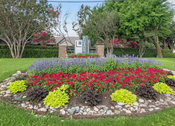 a flower garden in front of a house