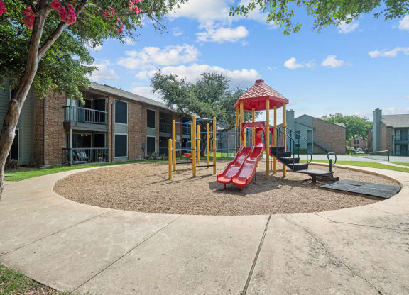 a playground at the whispering winds apartments in pearland, tx