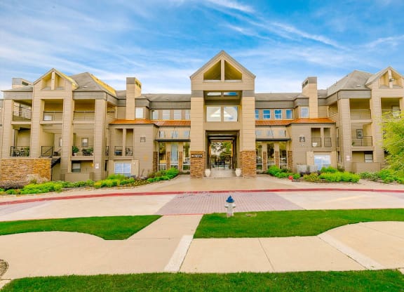 a large building with a lawn in front of it