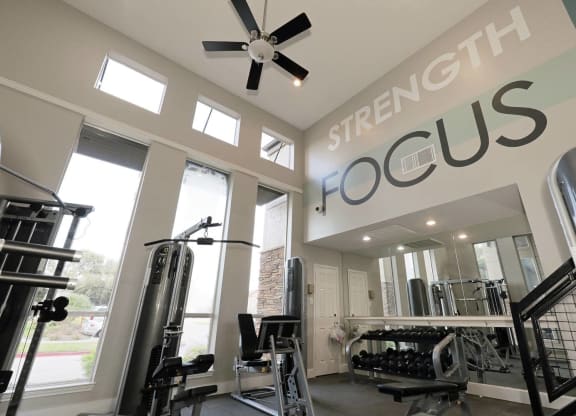 a home gym with a sign that says strength focus