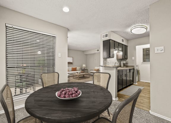 a dining room table with a bowl of fruit on it at Legacy Apartments in Plano, TX