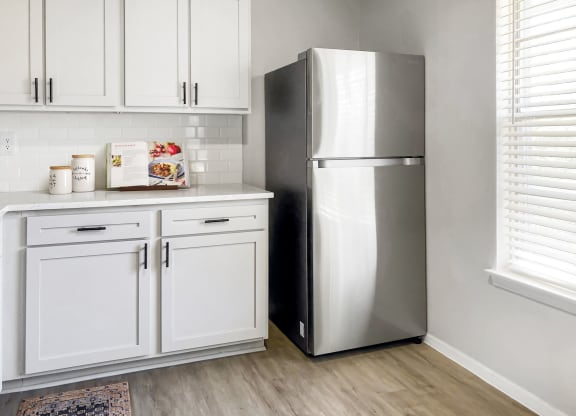 a kitchen with white cabinets and a stainless steel refrigerator  at Sunset Heights, Texas, 78209