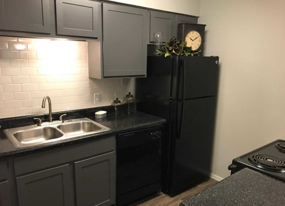 a kitchen with a sink and a refrigerator