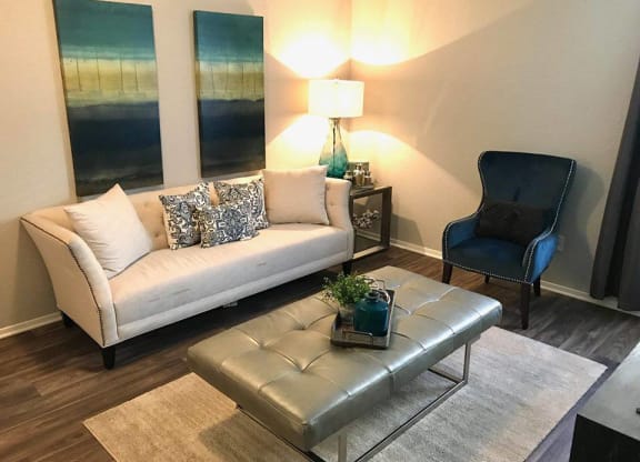a living room with a couch chair and table