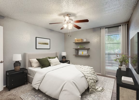 our apartments offer a bedroom with a large bed and a ceiling fan