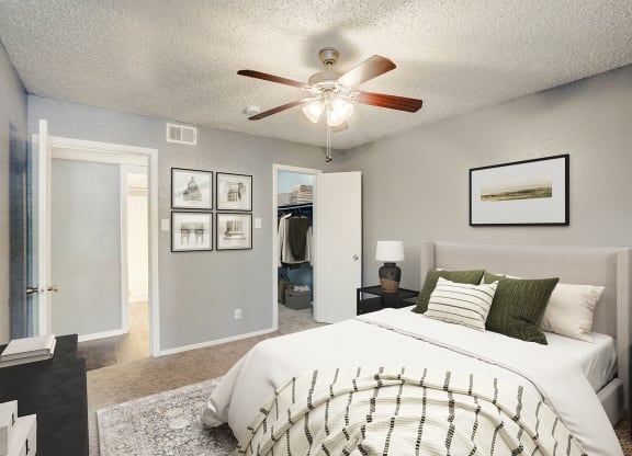 an open bedroom with a large bed and a ceiling fan