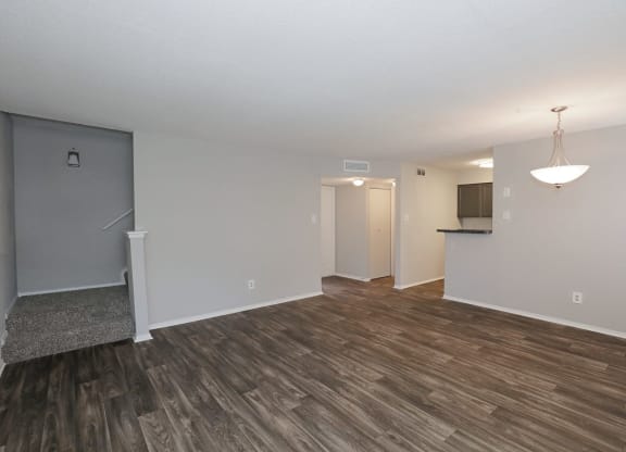 a living room with hardwood floors and grey walls