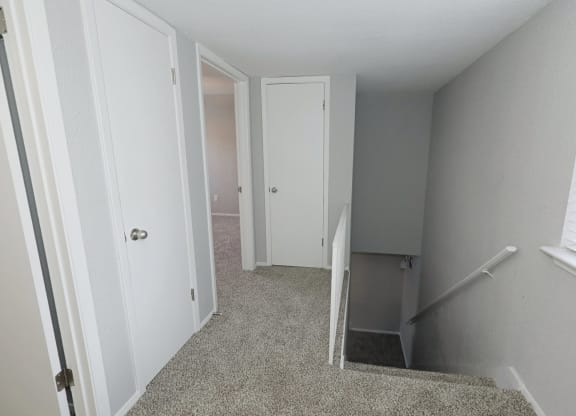 a bedroom with a bed and a mirror on the wall